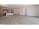 Open floor plan with wood-style tile flooring connecting the living area to the kitchen at 21427 W Meadowbrook Ave, Buckeye, AZ 85396