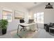 Staged office space has a large desk, comfortable seating, and ample natural light, perfect for working from home at 21427 W Meadowbrook Ave, Buckeye, AZ 85396