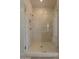 Modern walk-in shower featuring a tiled surround and glass door at 21427 W Meadowbrook Ave, Buckeye, AZ 85396