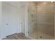 Modern shower with a glass enclosure and tiled walls at 21427 W Meadowbrook Ave, Buckeye, AZ 85396
