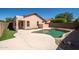 Backyard with a pool, manicured lawn, and stucco exterior of a home in Arizona at 21632 N 48Th St, Phoenix, AZ 85054