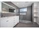 Updated bathroom featuring a large lighted mirror, walk-in shower and gray walls at 21632 N 48Th St, Phoenix, AZ 85054