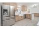 Spacious kitchen featuring stainless steel appliances, light wood cabinets and white countertops at 21632 N 48Th St, Phoenix, AZ 85054