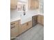 The kitchen features stainless appliances, a farmhouse sink and light wood cabinets at 21632 N 48Th St, Phoenix, AZ 85054