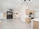 Open-concept living room with sleek fireplace, modern lighting, and wood-look tile flooring at 21632 N 48Th St, Phoenix, AZ 85054