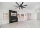 Bright living room featuring a modern fireplace, large windows, and stylish ceiling fan at 21632 N 48Th St, Phoenix, AZ 85054