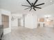 Spacious living room with an open floor plan, modern ceiling fan, and views to the kitchen at 21632 N 48Th St, Phoenix, AZ 85054
