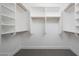 The organized walk-in closet features wooden shelving and neutral walls at 21632 N 48Th St, Phoenix, AZ 85054