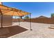 Backyard features covered patio area and gravel landscaping for minimal maintenance at 22547 W Pima St, Buckeye, AZ 85326