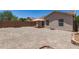 Large backyard featuring a covered patio area, gravel landscaping, and block fence at 22547 W Pima St, Buckeye, AZ 85326
