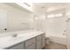 Bathroom featuring sleek vanity, shower-tub combo, and a bright window at 22547 W Pima St, Buckeye, AZ 85326