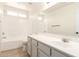 Bathroom featuring sleek vanity, shower-tub combo, and a bright window at 22547 W Pima St, Buckeye, AZ 85326