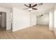 A bedroom featuring light wood flooring, a ceiling fan, and mirrored sliding closet doors at 22547 W Pima St, Buckeye, AZ 85326