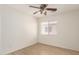 Bedroom featuring light wood flooring, a ceiling fan, and a bright window at 22547 W Pima St, Buckeye, AZ 85326