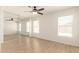 Bright bedroom featuring a ceiling fan, two windows, and a mirrored closet at 22547 W Pima St, Buckeye, AZ 85326