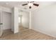 A bedroom featuring an open closet with sliding mirrored doors and light wood flooring at 22547 W Pima St, Buckeye, AZ 85326