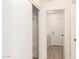Hallway features open storage with shelving along with a laundry area at the end of the hall at 22547 W Pima St, Buckeye, AZ 85326