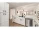 Modern kitchen with stainless steel appliances and white cabinets, open to the living area at 22547 W Pima St, Buckeye, AZ 85326