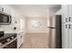 Bright kitchen featuring stainless steel appliances, white cabinets, and modern countertops at 22547 W Pima St, Buckeye, AZ 85326