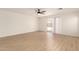 Light-filled living room with wood-look floors and sliding glass door at 22547 W Pima St, Buckeye, AZ 85326