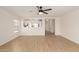 Open-concept living room with wood-look floors and a view into the modern kitchen at 22547 W Pima St, Buckeye, AZ 85326