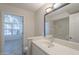 Bright bathroom with sink, large mirror, and a doorway looking into another room at 2333 E Southern Ave # 1023, Tempe, AZ 85282