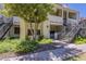 Charming condo building with stairs, stucco exterior, and lush green landscaping at 2333 E Southern Ave # 1023, Tempe, AZ 85282