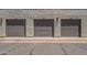 Three garage doors side-by-side with their corresponding unit numbers on the stucco building at 2333 E Southern Ave # 1023, Tempe, AZ 85282