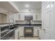 Modern kitchen with black countertops, stainless steel appliances, and white cabinets at 2333 E Southern Ave # 1023, Tempe, AZ 85282