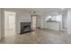Open concept living room with tile floors and a cozy fireplace leading into the kitchen at 2333 E Southern Ave # 1023, Tempe, AZ 85282