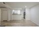 Open-concept living room featuring tile floors connecting to a kitchen with stainless steel appliances at 2333 E Southern Ave # 1023, Tempe, AZ 85282