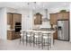 Spacious kitchen boasts an island with seating, stainless appliances, and stylish wood cabinetry at 24223 W Illini St, Buckeye, AZ 85326