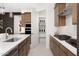 Modern kitchen features stainless appliances, gas range, pantry, quartz countertops, and stylish fixtures at 24223 W Illini St, Buckeye, AZ 85326