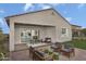 Covered patio with outdoor furniture, a dining table, and view into the home's living room at 24223 W Illini St, Buckeye, AZ 85326