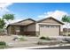 Charming single-story home featuring a neutral color palette, stone accents, and a two-car garage at 24254 W Agora Ln, Buckeye, AZ 85326