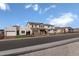 Wide street view displaying a collection of stylish homes each adorned with welcoming front yards at 24254 W Agora Ln, Buckeye, AZ 85326