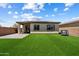 A well-kept backyard with artificial turf, a covered patio, and low-maintenance landscaping at 2753 E Fossil Ridge Rd, Phoenix, AZ 85050
