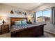 Cozy bedroom featuring a wooden bed frame, side tables, and a window with natural light at 2753 E Fossil Ridge Rd, Phoenix, AZ 85050