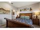 Cozy bedroom featuring a decorative sleigh bed, unique accents, and en-suite bathroom access at 2753 E Fossil Ridge Rd, Phoenix, AZ 85050