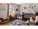 Charming Bedroom with playful decor, a crib, and a rocking chair on top of plush carpet at 2753 E Fossil Ridge Rd, Phoenix, AZ 85050