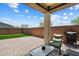 A covered patio with stone flooring, outdoor seating, and a built-in grill at 2753 E Fossil Ridge Rd, Phoenix, AZ 85050