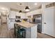Modern kitchen with white cabinets, stainless steel appliances, and an island with seating at 2753 E Fossil Ridge Rd, Phoenix, AZ 85050