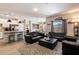 Open concept living area, featuring a kitchen, dining area, and comfortable seating on a patterned rug at 2753 E Fossil Ridge Rd, Phoenix, AZ 85050