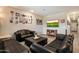 Cozy living room featuring leather sofas, a television, and a gallery wall for a personalized touch at 2753 E Fossil Ridge Rd, Phoenix, AZ 85050