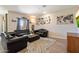 Spacious living room featuring leather seating, area rug, and ample natural light at 2753 E Fossil Ridge Rd, Phoenix, AZ 85050