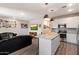 Open concept living area featuring a kitchen island, stainless appliances, and comfortable seating area at 2753 E Fossil Ridge Rd, Phoenix, AZ 85050