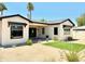 Charming backyard featuring desert landscaping, manicured lawn and covered patio at 3021 N 47Th St, Phoenix, AZ 85018