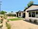 Beautifully landscaped backyard with desert plants, manicured lawn, and shaded patio at 3021 N 47Th St, Phoenix, AZ 85018