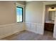 Bright bedroom showcasing panel molding and a view into the en-suite bathroom at 3021 N 47Th St, Phoenix, AZ 85018