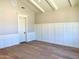 Bedroom with light wood floors, paneled walls, white trim and vaulted ceilings at 3021 N 47Th St, Phoenix, AZ 85018